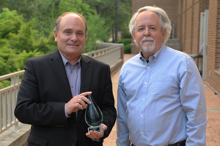Unifi CEO Kevin Hall receiving the award from Al Segars, PNC distinguished professor, strategy and entrepreneurship and faculty director, at the Center for Sustainable Enterprise.